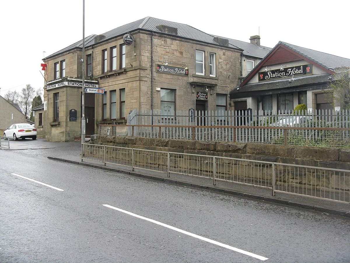 The stone-built Station Hotel in Shotts, beside the road