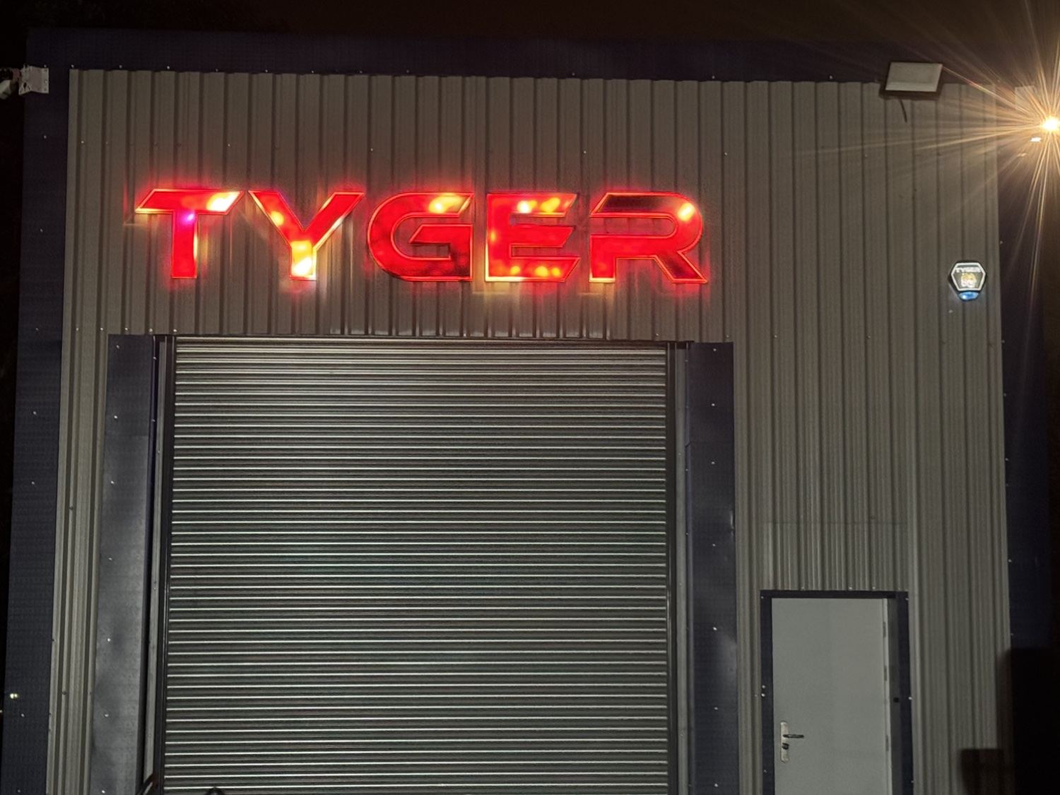 Tyger Security unit at night, lit by an LED security floodlight above the roller door